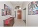 Inviting entryway with wood-toned furniture and framed artwork at 18840 N 83Rd Ln, Peoria, AZ 85382