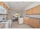 Bright kitchen with light wood cabinets, ample counter space, and a breakfast nook at 18840 N 83Rd Ln, Peoria, AZ 85382