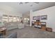 Spacious living room featuring a comfortable sectional sofa and built-in shelving at 18840 N 83Rd Ln, Peoria, AZ 85382