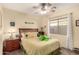 Cozy bedroom with striped bedding and ceiling fan at 18927 N Leland Rd, Maricopa, AZ 85138