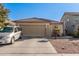 Single-story home with a two-car garage and desert landscaping at 18927 N Leland Rd, Maricopa, AZ 85138