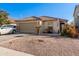 Single-story home with a two-car garage and desert landscaping at 18927 N Leland Rd, Maricopa, AZ 85138