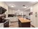 Spacious kitchen with island, white cabinets, and stainless steel appliances at 18927 N Leland Rd, Maricopa, AZ 85138