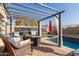 Peaceful patio with wicker furniture and pergola, overlooking the pool at 18927 N Leland Rd, Maricopa, AZ 85138