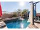 Refreshing pool with waterfall feature and surrounding patio at 18927 N Leland Rd, Maricopa, AZ 85138