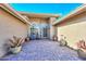 Inviting courtyard entry with brick pavers and potted plants at 19122 N 90Th Dr, Peoria, AZ 85382