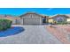 Beautiful curb appeal with a paved driveway and desert landscaping at 19122 N 90Th Dr, Peoria, AZ 85382