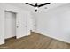 Bedroom with wood-look flooring, ceiling fan, and closet at 1914 E Golden Ct, Chandler, AZ 85225