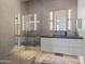 Modern bathroom with a glass shower, gray tile, and sleek vanity at 20646 N 112Th St, Scottsdale, AZ 85255