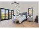 Main bedroom with balcony access and hardwood floors at 20646 N 112Th St, Scottsdale, AZ 85255