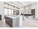 Open-concept living space with a marble fireplace, island kitchen, and herringbone floors at 20646 N 112Th St, Scottsdale, AZ 85255