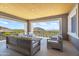 Covered patio with wooden furniture and mountain views at 20646 N 112Th St, Scottsdale, AZ 85255