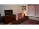 Bedroom with wooden dresser, comfy chair, and large TV at 2425 E Durango Dr, Casa Grande, AZ 85194