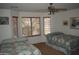 Bedroom with two twin beds, ceiling fan and large windows at 2425 E Durango Dr, Casa Grande, AZ 85194