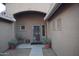 Front entry with decorative wrought iron door and potted plants at 2425 E Durango Dr, Casa Grande, AZ 85194