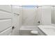 Clean bathroom, featuring a bathtub, shower, and marble wall tiles at 25570 N 154Th Ln, Surprise, AZ 85387