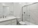 Modern bathroom with white cabinets, marble shower, and a single sink vanity at 25570 N 154Th Ln, Surprise, AZ 85387