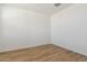 Simple bedroom with light brown wood flooring and neutral walls at 25570 N 154Th Ln, Surprise, AZ 85387