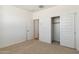 Bedroom with neutral carpet, white walls, and a closet at 25570 N 154Th Ln, Surprise, AZ 85387