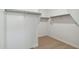 Large walk-in closet with double hanging rods and carpeted flooring at 25570 N 154Th Ln, Surprise, AZ 85387