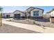 Modern house with neutral color scheme and desert landscaping at 25570 N 154Th Ln, Surprise, AZ 85387