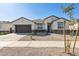 Newly built home with gray exterior and desert landscaping at 25570 N 154Th Ln, Surprise, AZ 85387