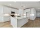 Modern kitchen with white cabinets, island, and tile flooring at 25570 N 154Th Ln, Surprise, AZ 85387