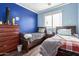 Bedroom with twin beds and blue walls at 25822 W Magnolia St, Buckeye, AZ 85326