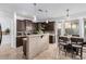 Modern kitchen with dark wood cabinets and a breakfast bar at 25822 W Magnolia St, Buckeye, AZ 85326