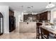 Modern kitchen with dark wood cabinets and a breakfast bar at 25822 W Magnolia St, Buckeye, AZ 85326