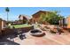 Backyard with fire pit, seating, and a lush green lawn at 2837 N Whiting Cir, Mesa, AZ 85213