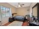 Cozy bedroom featuring a full bed, dresser, and window with curtains at 2837 N Whiting Cir, Mesa, AZ 85213