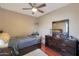 Spacious bedroom with a queen bed and dark wood dresser at 2837 N Whiting Cir, Mesa, AZ 85213