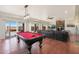 Game room features a pool table, comfortable seating, and fireplace at 2837 N Whiting Cir, Mesa, AZ 85213