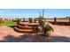 Landscaped patio with fire pit, seating area, and desert plants at 2837 N Whiting Cir, Mesa, AZ 85213