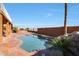 Relaxing kidney-shaped pool with surrounding patio; inviting backyard oasis at 2837 N Whiting Cir, Mesa, AZ 85213