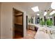 Bathroom with double vanity, skylights, and spacious walk-in shower at 3013 W Phelps Rd, Phoenix, AZ 85053