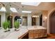 Bathroom with a large vanity, skylights, and terracotta tile floors at 3013 W Phelps Rd, Phoenix, AZ 85053