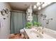 Bathroom with updated vanity, shower/tub combo, and tiled floor at 3013 W Phelps Rd, Phoenix, AZ 85053