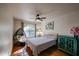 Bedroom with striped bedding, ceiling fan, and arched window at 3013 W Phelps Rd, Phoenix, AZ 85053