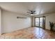 Bedroom with terracotta tile floors, French doors, and ceiling fan at 3013 W Phelps Rd, Phoenix, AZ 85053