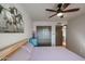 Bedroom with ceiling fan, double doors, and striped bedding at 3013 W Phelps Rd, Phoenix, AZ 85053