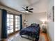 Bedroom with queen bed, access to patio, and ceiling fan at 3013 W Phelps Rd, Phoenix, AZ 85053