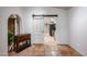 Dining room with terracotta tile floors, a barn door, and views into the kitchen at 3013 W Phelps Rd, Phoenix, AZ 85053