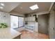 Bright laundry room with wood laminate counters, cabinets, and tile floors at 3013 W Phelps Rd, Phoenix, AZ 85053