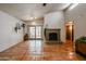 Living room with fireplace and terracotta tile floors at 3013 W Phelps Rd, Phoenix, AZ 85053