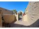 Private courtyard patio with wrought-iron gate and brick pavers at 3013 W Phelps Rd, Phoenix, AZ 85053