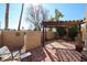 Private patio with pergola, brick pavers, and mature trees at 3013 W Phelps Rd, Phoenix, AZ 85053