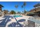 Inviting pool area with lounge chairs, tables, and palm trees at 3013 W Phelps Rd, Phoenix, AZ 85053