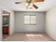 Bright bedroom with carpet flooring, ceiling fan, and access to a bathroom at 30573 N Royal Oak Way, San Tan Valley, AZ 85143